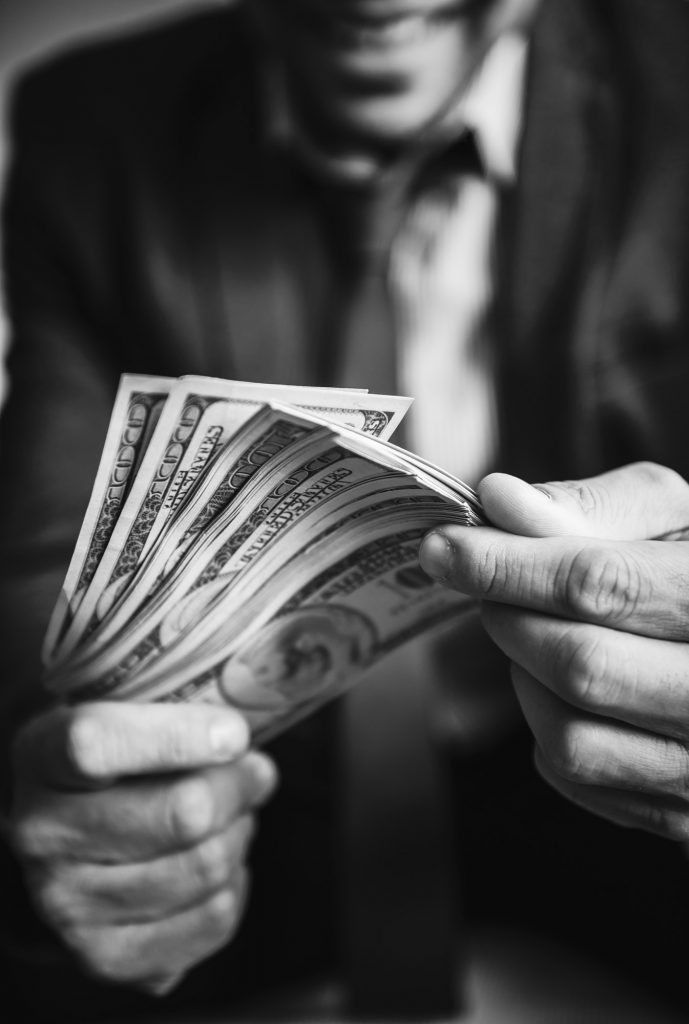 A person carrying a lot of cash by Rawpixel