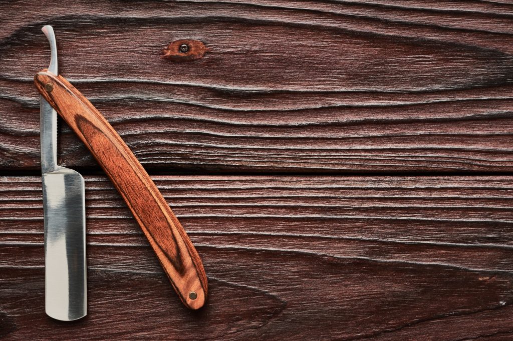 Vintage barber shop straight razor by haveseentool on wooden background