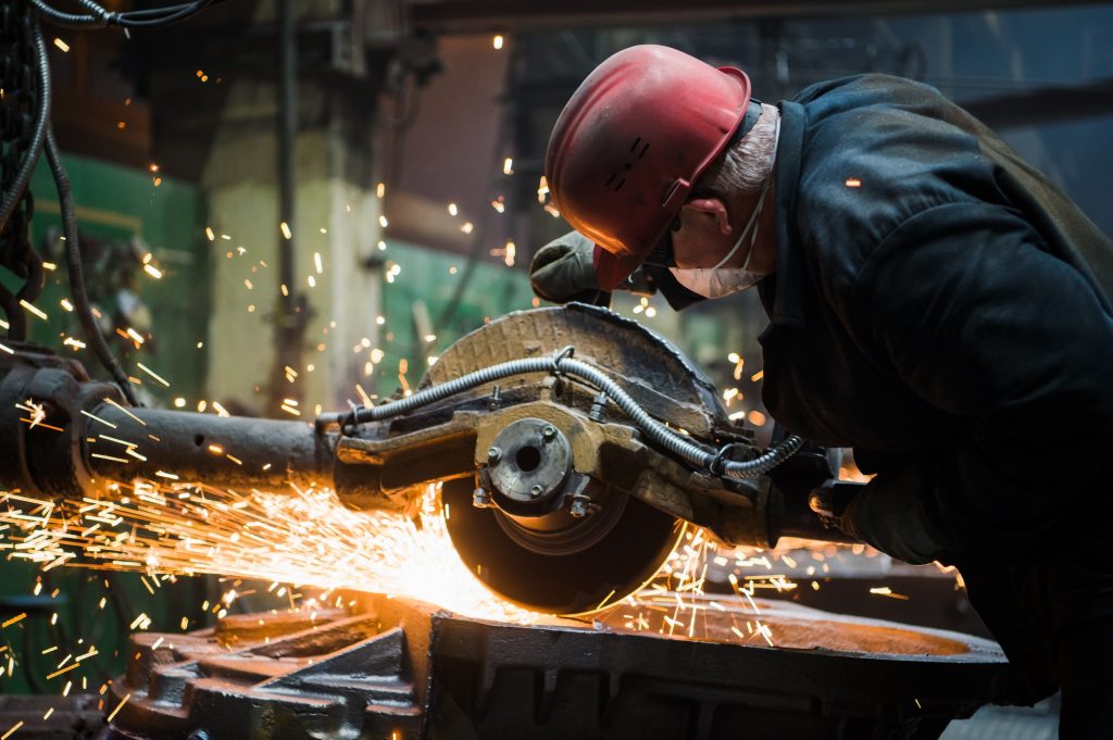 Worker grinding metal, metal grinding machine with sparks, metal sawing by romankosolapov