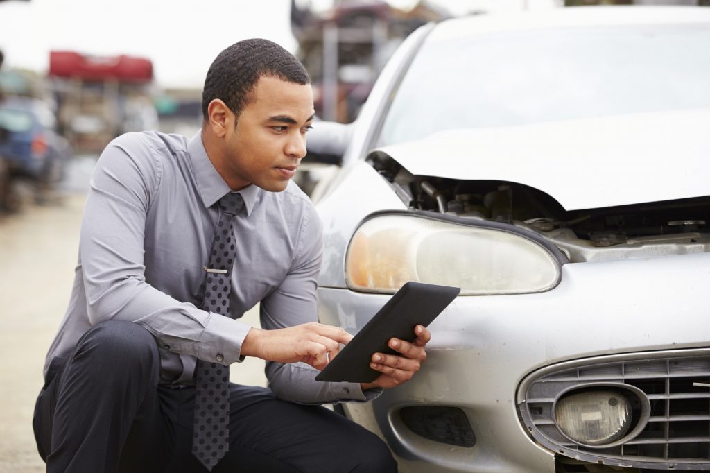 Loss Adjuster Using Digital Tablet In Car Wreck Inspection @monkeybusiness
